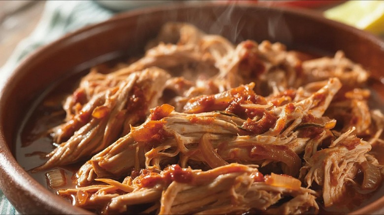 pulled pork steams in brown bowl