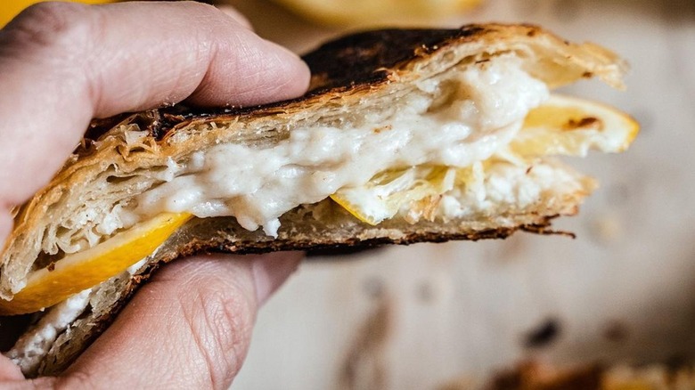 Smashed croissant grilled cheese sandwich