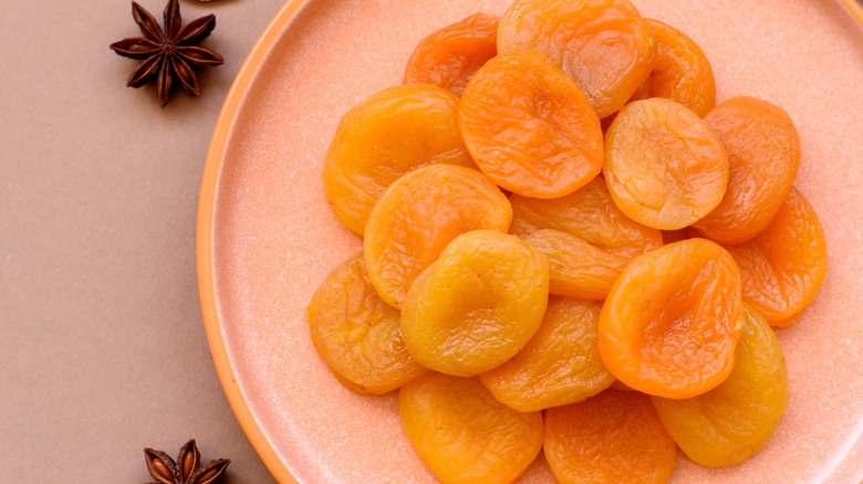 dried apricots on a plate with star anise