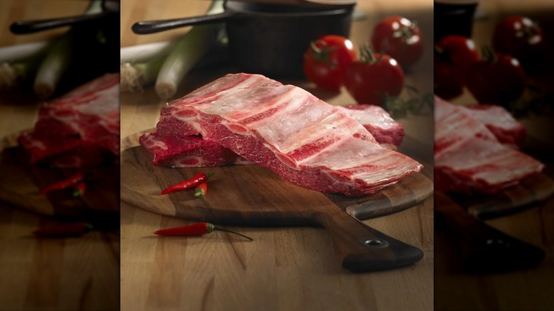 raw bison short ribs on cutting board
