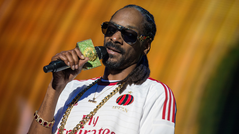 Snoop Dogg with gold microphone and gold necklace