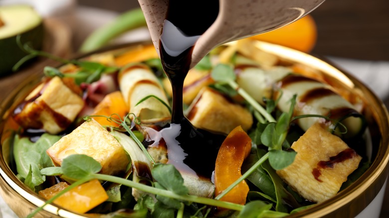 Balsamic vinegar poured over salad