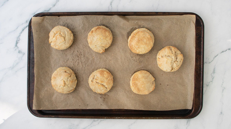 A large baking sheet with baked biscuits