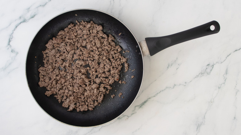 A large skillet filled with cooked breakfast sausage