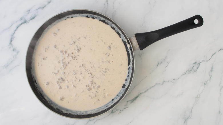A creamy sausage gravy in a large skillet