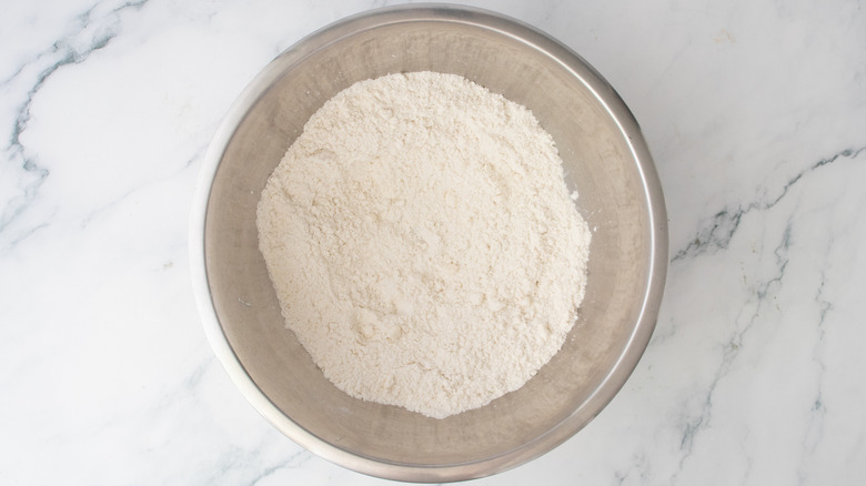 A large bowl with small crumbles of flour and butter