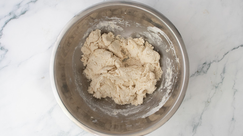 Shaggy biscuit dough in metal bowl