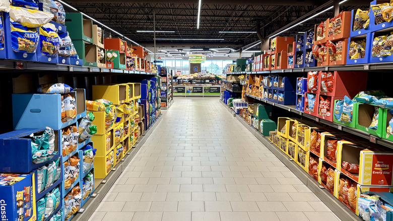 Aldi interior aisle showing bags of chips and other snacks.