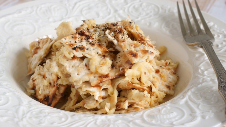 matzoh brei served in white bowl with fork