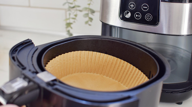 An air fryer drawer with a liner inside
