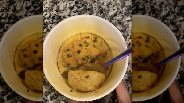 scooping egg out of ramen bowl