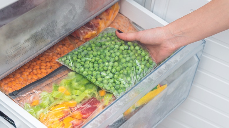 pulling frozen veggies from freezer drawer
