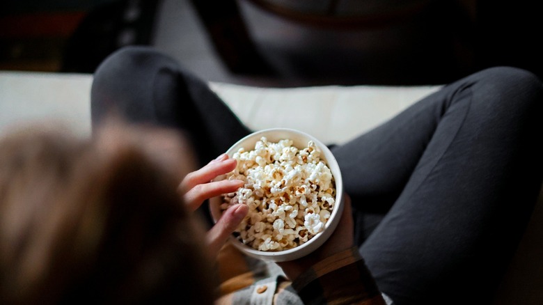 back view of person eating popcorn