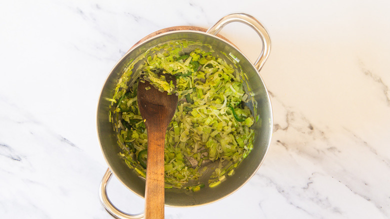 Stirring leeks and jalapeno in soup pot