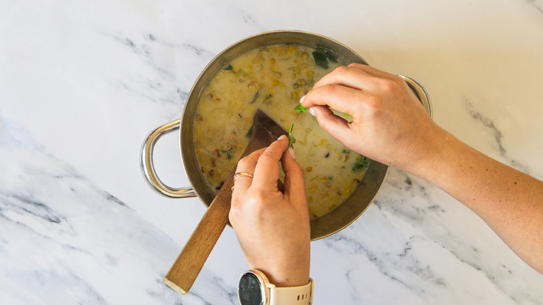 Adding basil to soup