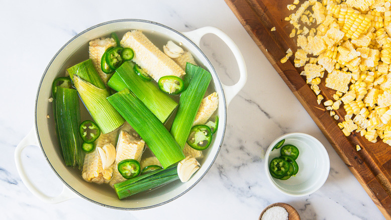 Leeks and jalapeno slices in stock pot