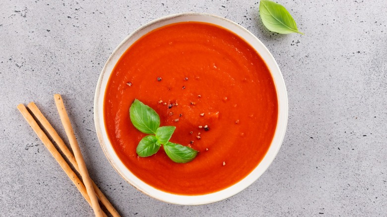 bowl of tomato soup with herbs
