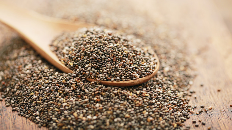 wooden spoon filled with overflowing chia seeds