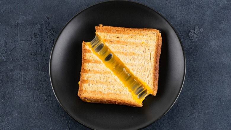 grilled cheese sandwich on black plate