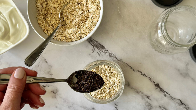 spooning chia seeds into mason jar