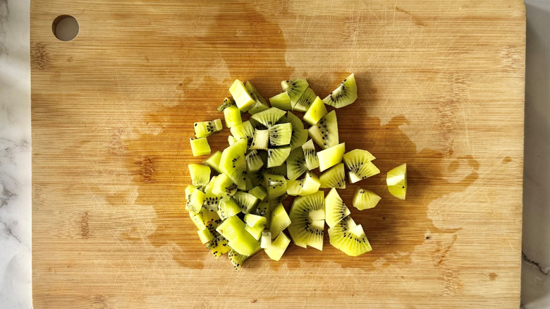 peeled and diced kiwi on cutting board