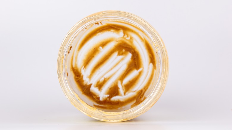 nearly empty peanut butter jar