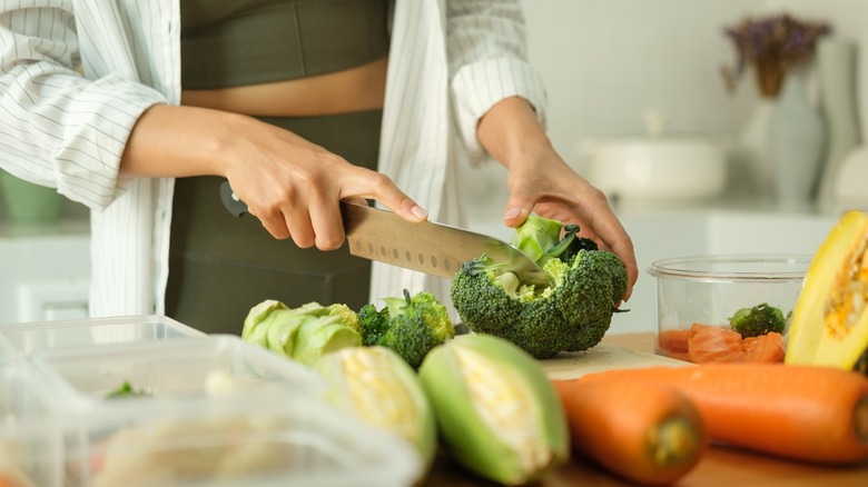 cutting lots of fresh produce on cutting board