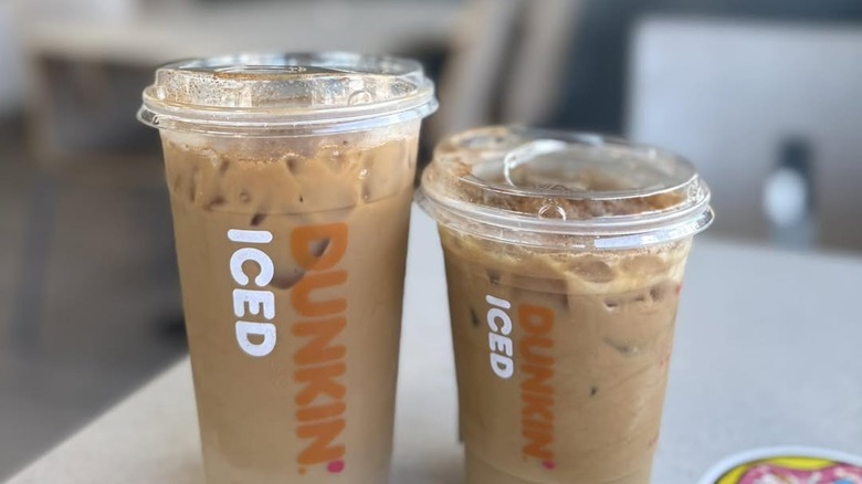 Two plastic cups of Dunkin' Brown Sugar Shakin' Espresso on table