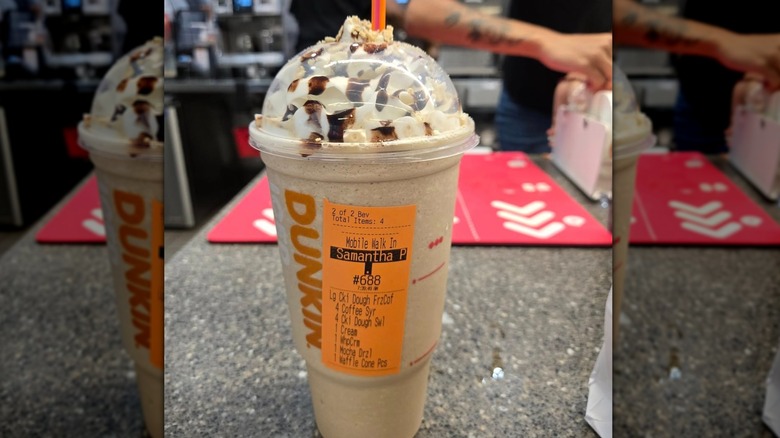 Plastic cup with domed lid of Dunkin' Cookie Dough Frozen Coffee