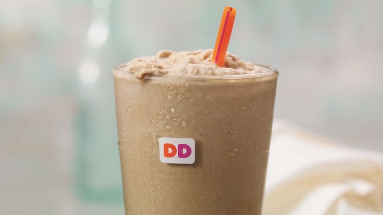 Glass of Dunkin' frozen coffee with straw