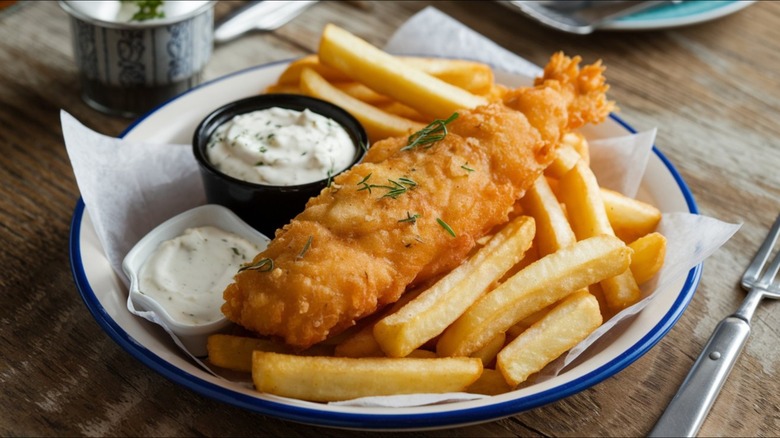 fish and chips with tartar sauce on a plate
