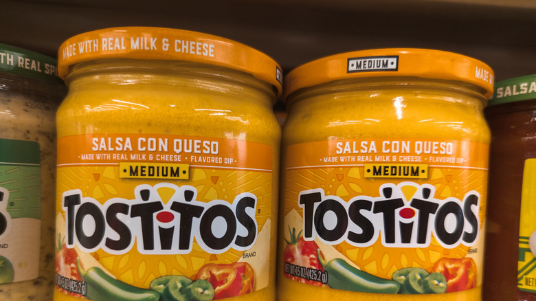 tostito's queso in jar on shelf