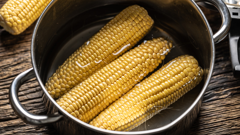 Corn ready to boil in a pot.