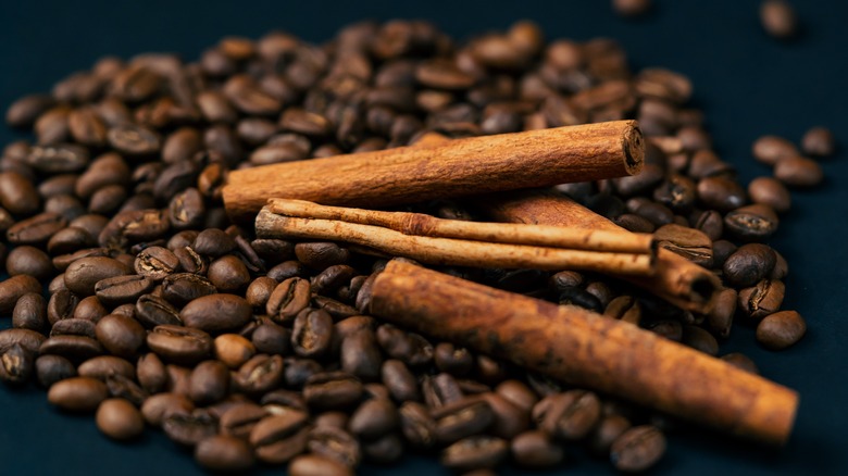Cinnamon sticks on top of coffee beans