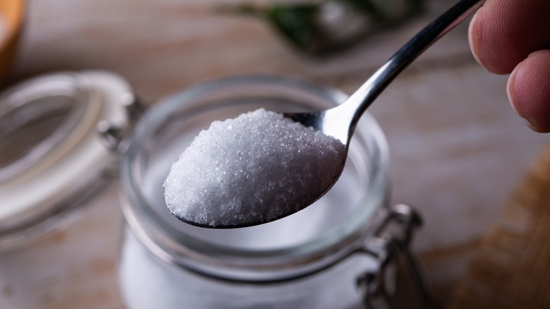 A close-up of a spoonful of erythritol sugar substitute