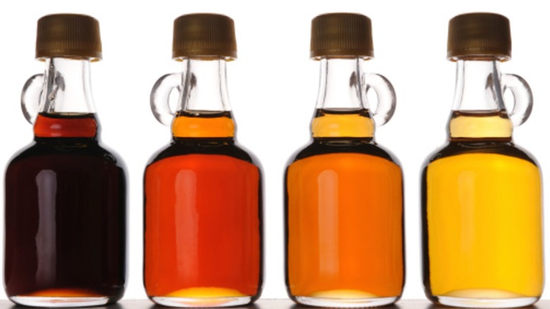 Four bottles of maple syrup showing their range of colors