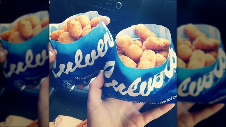 hands hold bags of culver's cheese curds