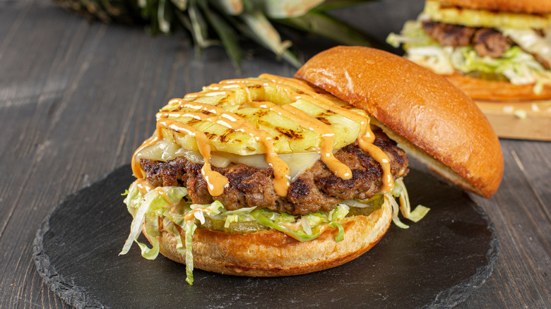 Burger with slice of charred pineapple on top
