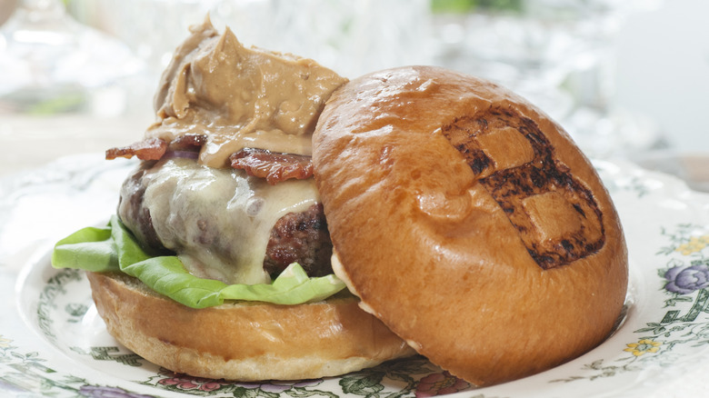 A burger topped with peanut butter