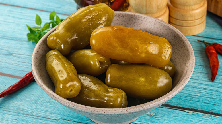 A bowl of pickled green tomatoes