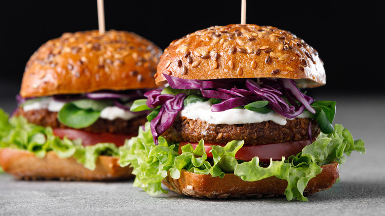 Two vegetable burgers with a yogurt topping