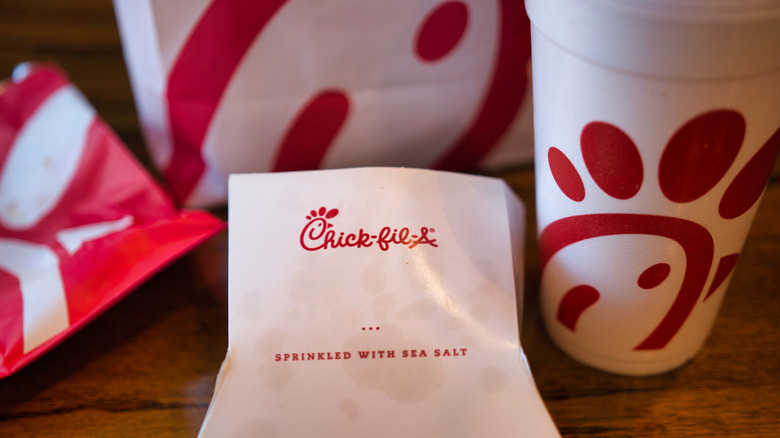 Chick-fil-A bags and cups on table, close-up