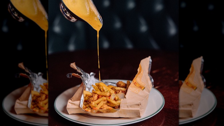 Gravy being poured on a spice bag at McGonagle's Irish Pub and Restaurant in Boston