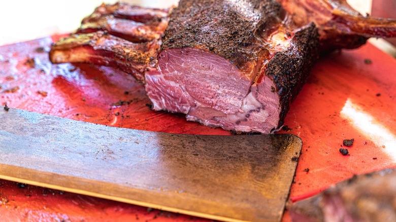 smoked bone-in prime rib on wooden surface