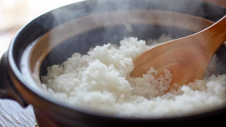 scooping rice out of pot