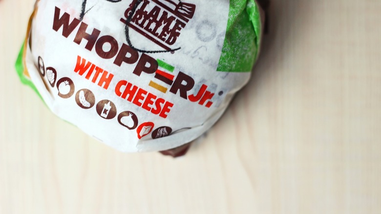 whopper jr. in wrapper on table