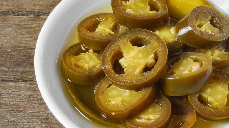 canned pickled peppers on a white dish