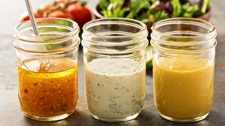 Close-up of glassware jars filled with dressings