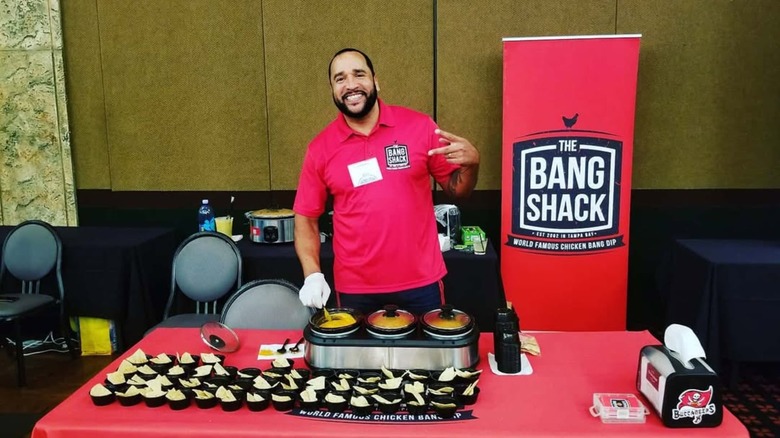 Jason Hadley smiling at table with The Bang Shack prodcuts