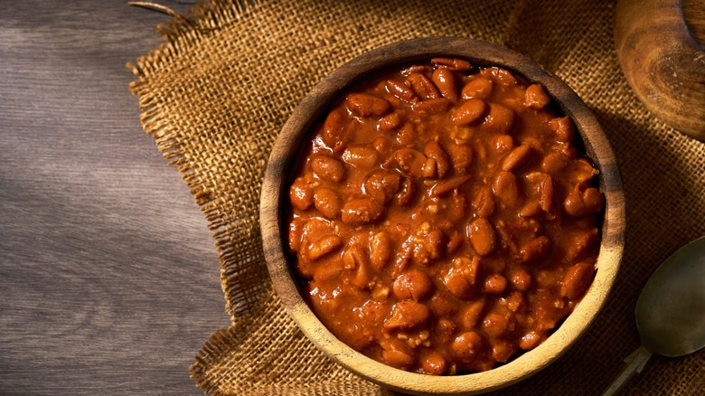 charro beans in wooden bowl with rustic tablescape